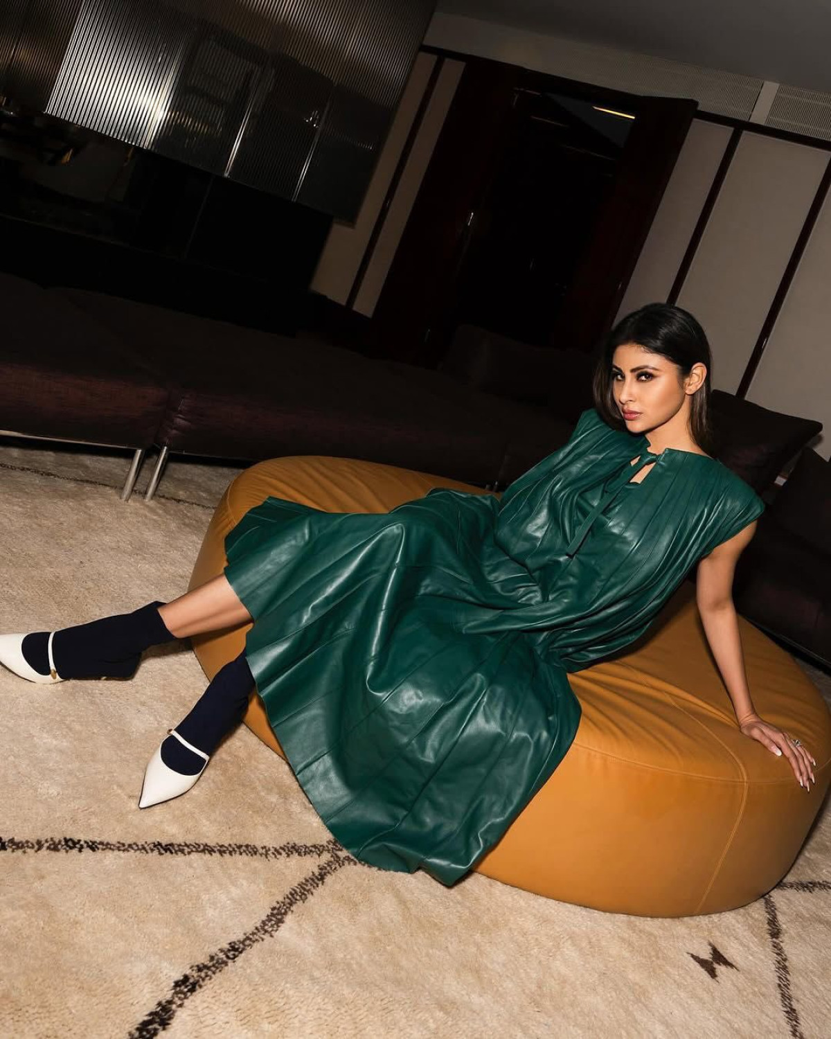 Mouni Roy dazzles in a flared nappa leather dress paired with classy boots for a chic look.