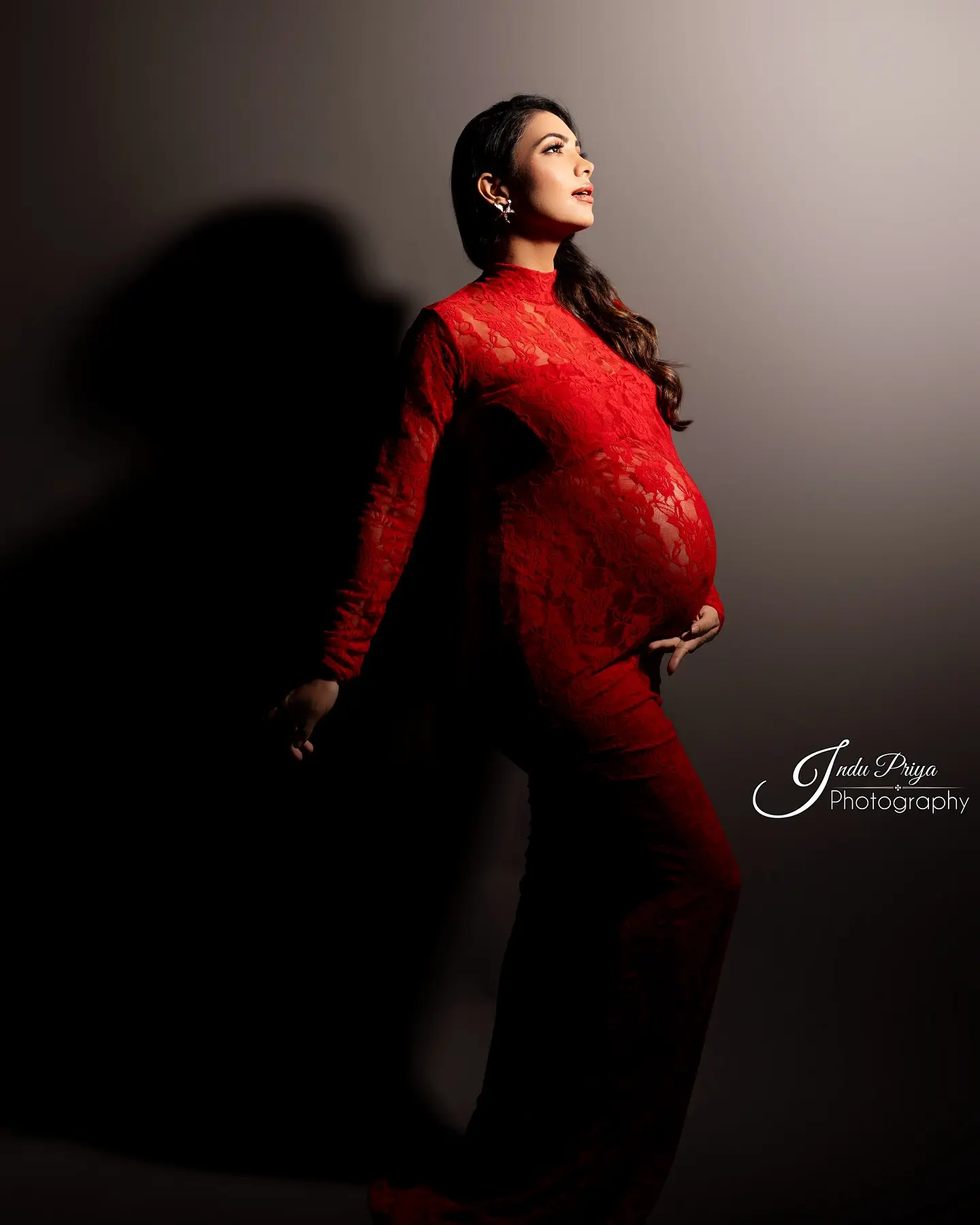 Radiant Maternity Shoot Shines With Celebrity Pooja Banerjee A stunning celebration of strength and motherhood, exquisitely framed in bold red style..