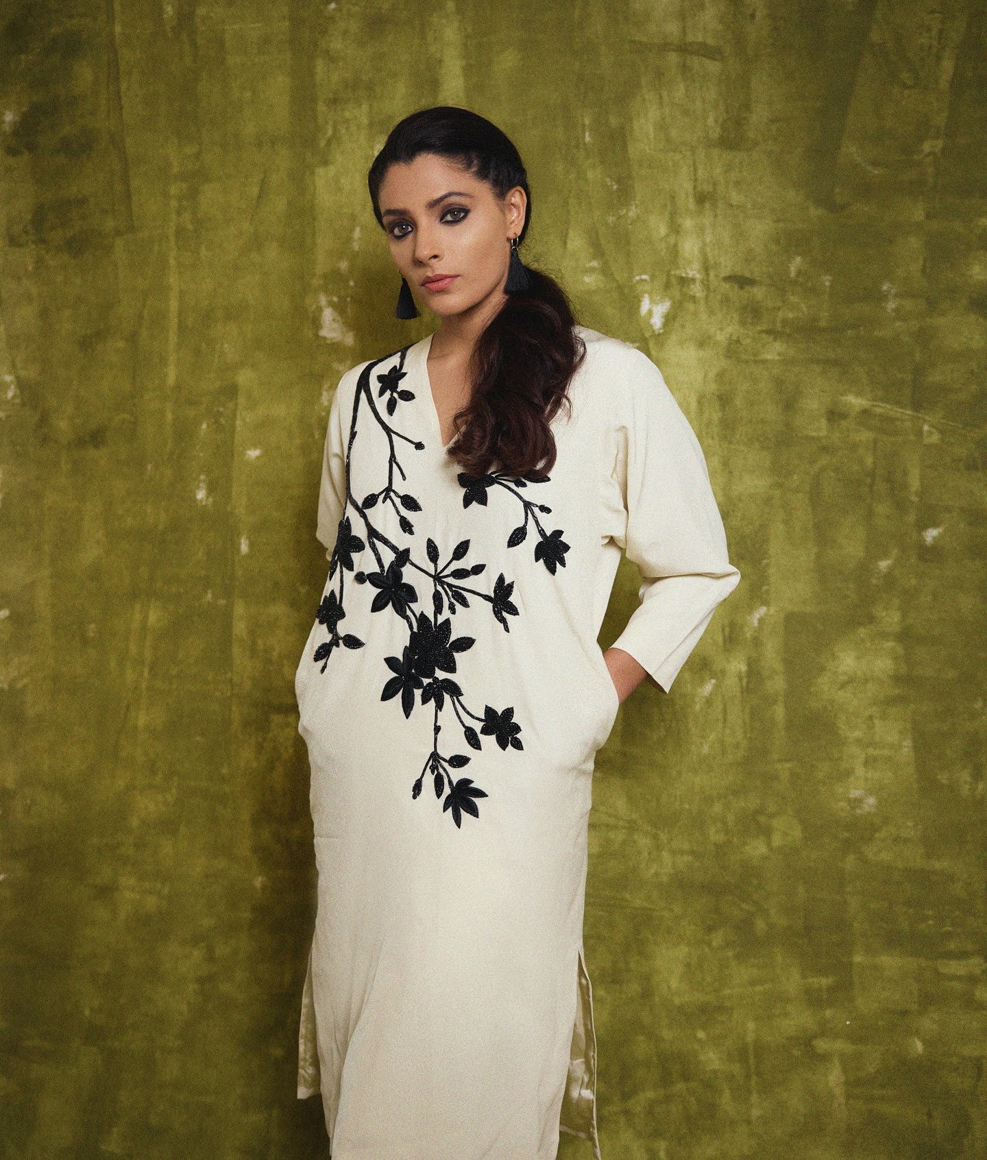 The actress displays timeless charm in a graceful, traditional ensemble.