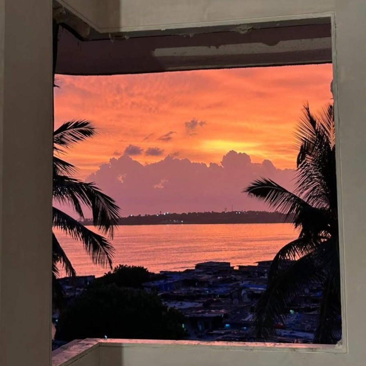 Sky Ablaze: Room View Captivates With Fiery Horizon Fiery room view captures a vibrant, blazing sky merging nature’s wonder with urban charm.!