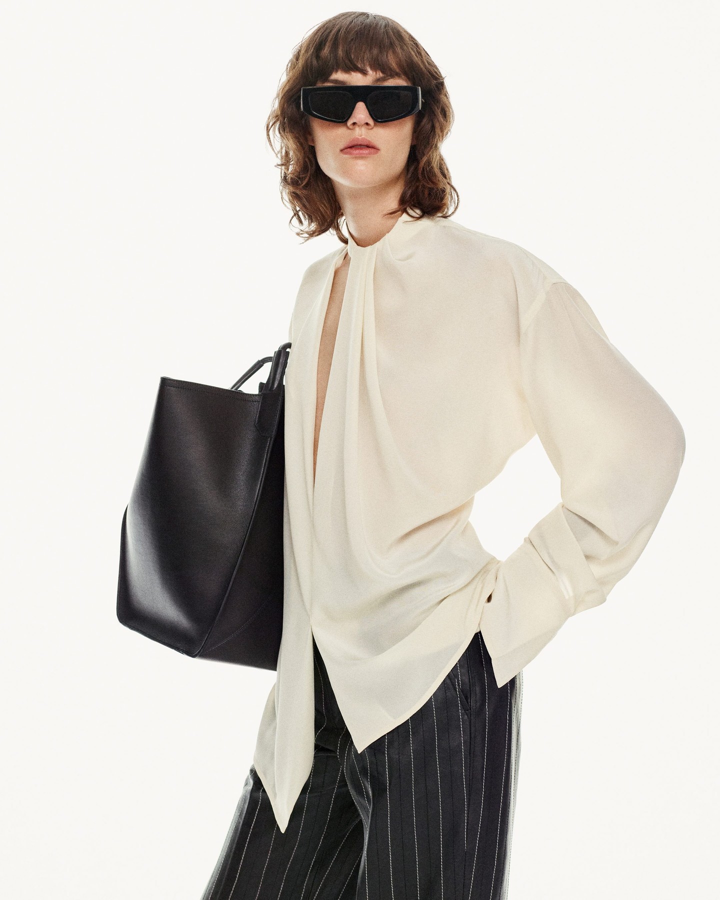 Italian finesse meets modern edge in Victoria Beckham’s black tote, a chic debut. Shop now
