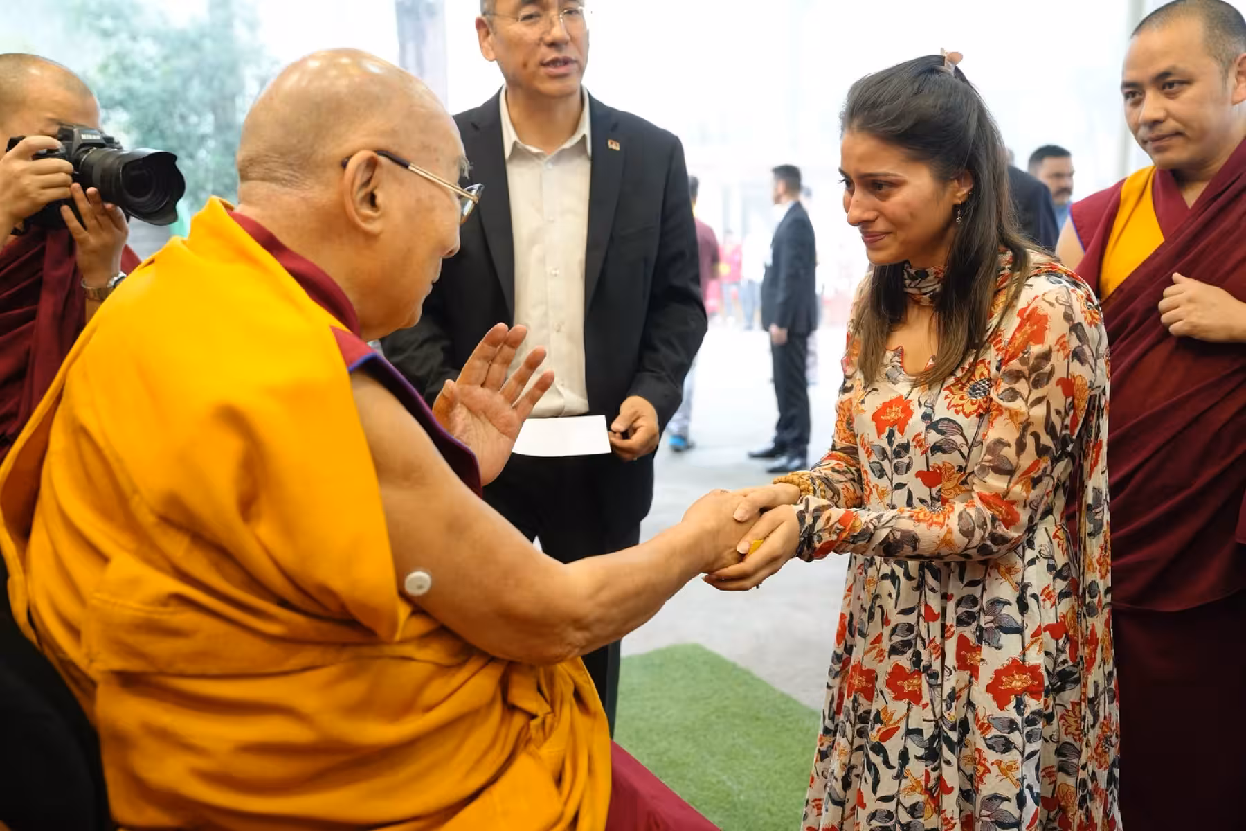 Aparna Dixit Receives Dalai Lama’s Blessings Spiritual connection inspires deep emotions, during hand-holding moment with revered sage.